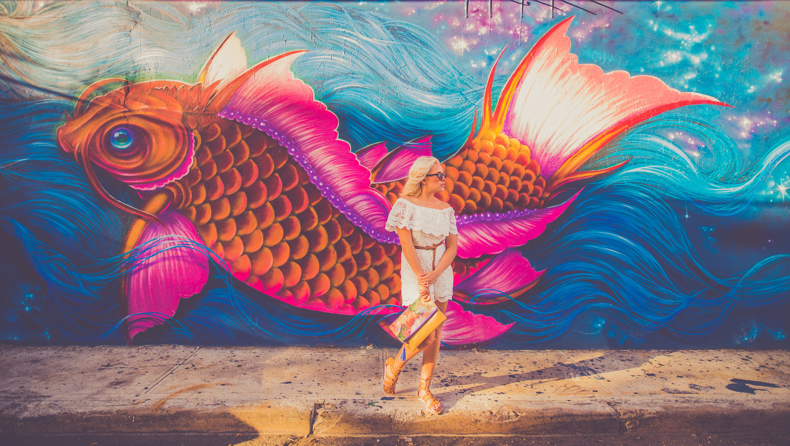 Woman Standing Near Fish Graphic Wall